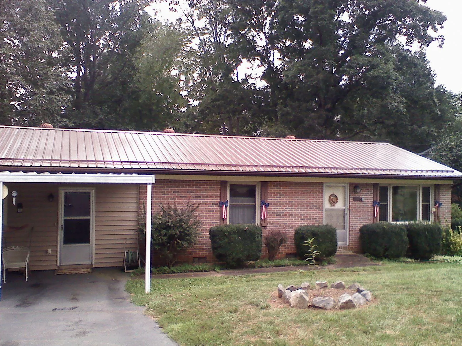 Bronze metal roof and carport on a brick ranch home — Roof Repair work by our crew in Rosemary Beach